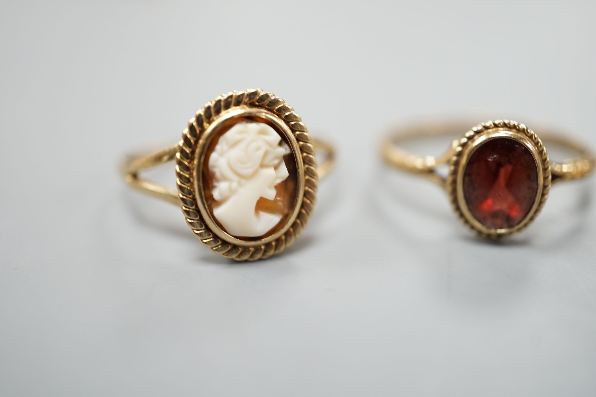 A late Victorian 15ct gold, seed pearl and amethyst cluster set ring, size L, gross 2.1 grams and two later 9ct gold rings including cameo shell, gross 3.2 grams.